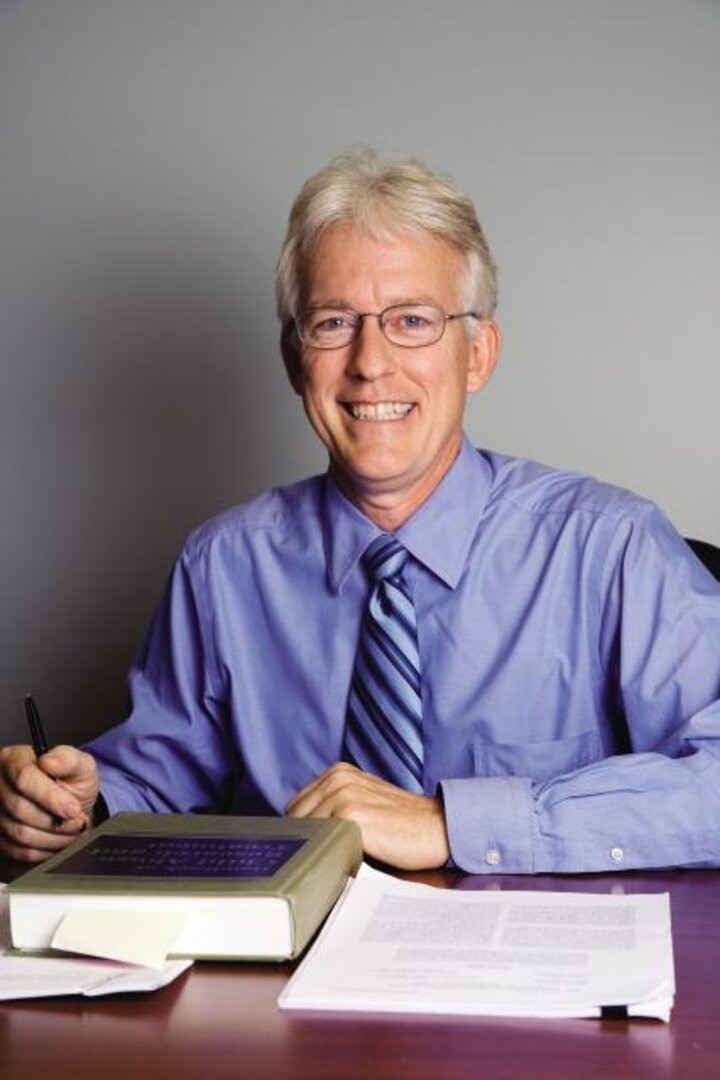 Dr. Dave Hansen sits at his desk